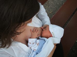 Baby Breastfeeding with Mother