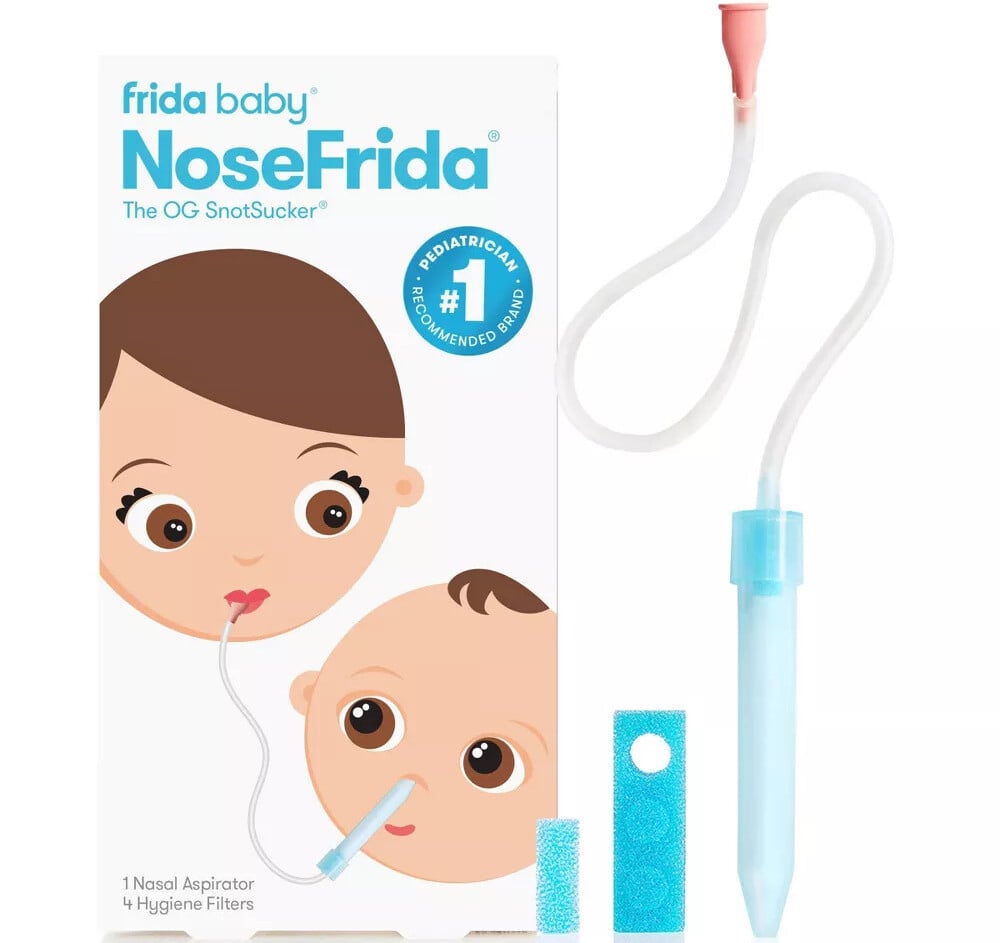 Box of the Frida Baby NoseFrida, labeled The OG SnotSucker, features a cartoon of a parent and baby using the nasal aspirator—an essential baby product for 2025. The package includes one aspirator and four hygiene filters, ensuring top-notch care for your little ones needs.